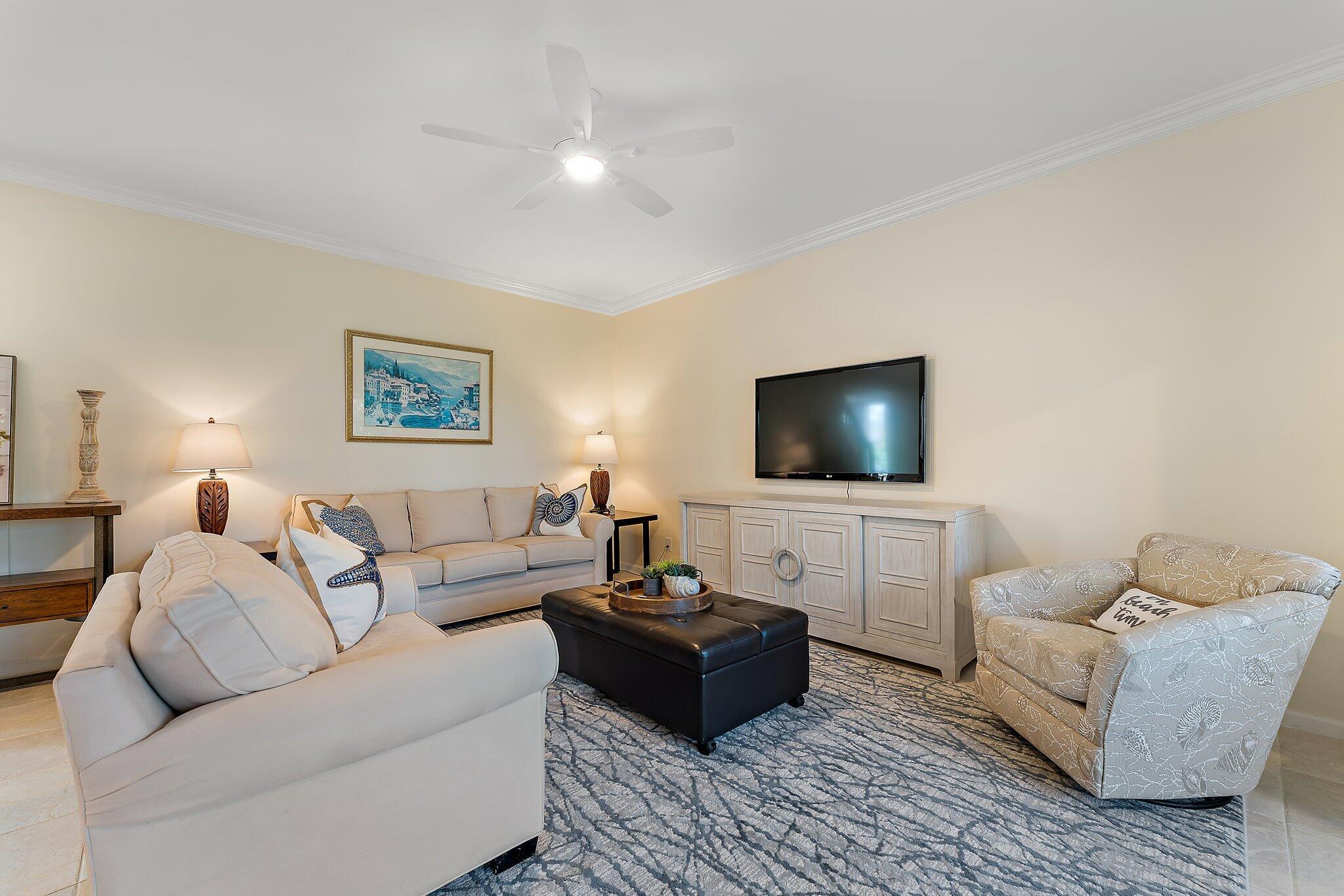 2905 Fairway Drive North Jupiter, FL 33477 - Photo 16 of 65 a living room with furniture and a flat screen tv