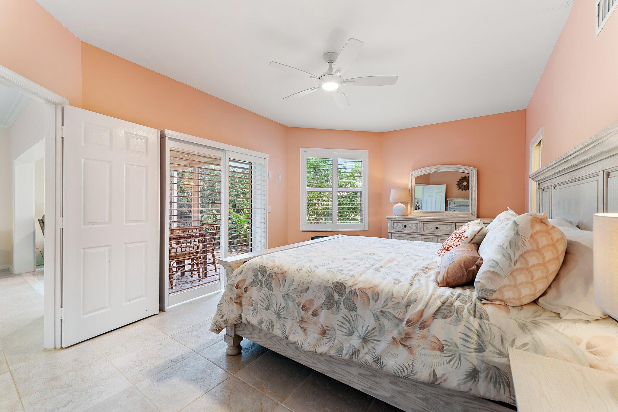 2905 Fairway Drive North Jupiter, FL 33477 - Photo 26 of 65 a bedroom with a large bed and a window