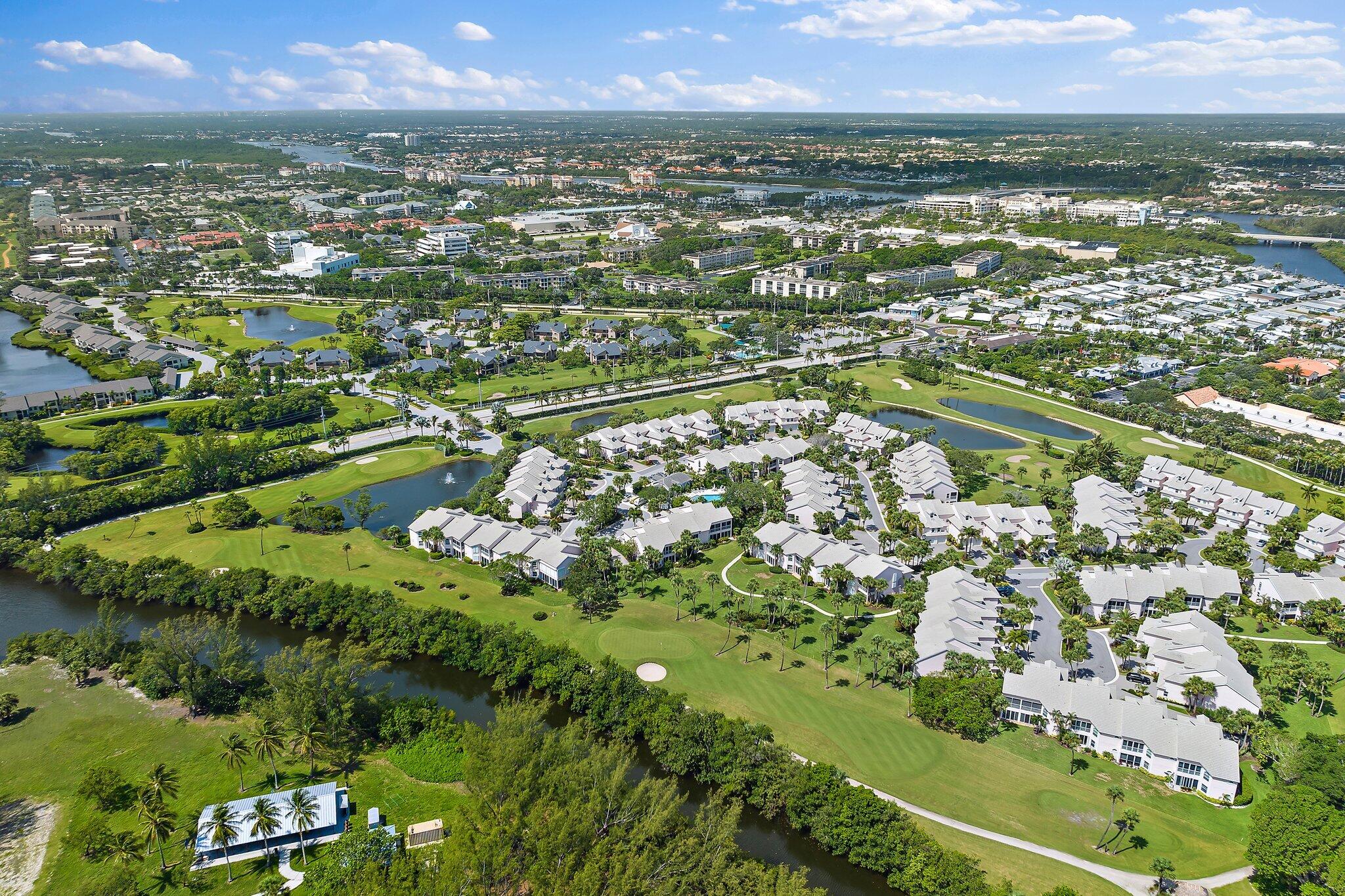 2905 Fairway Drive North Jupiter, FL 33477 - Photo 58 of 65 an aerial view of residential houses with outdoor space and trees