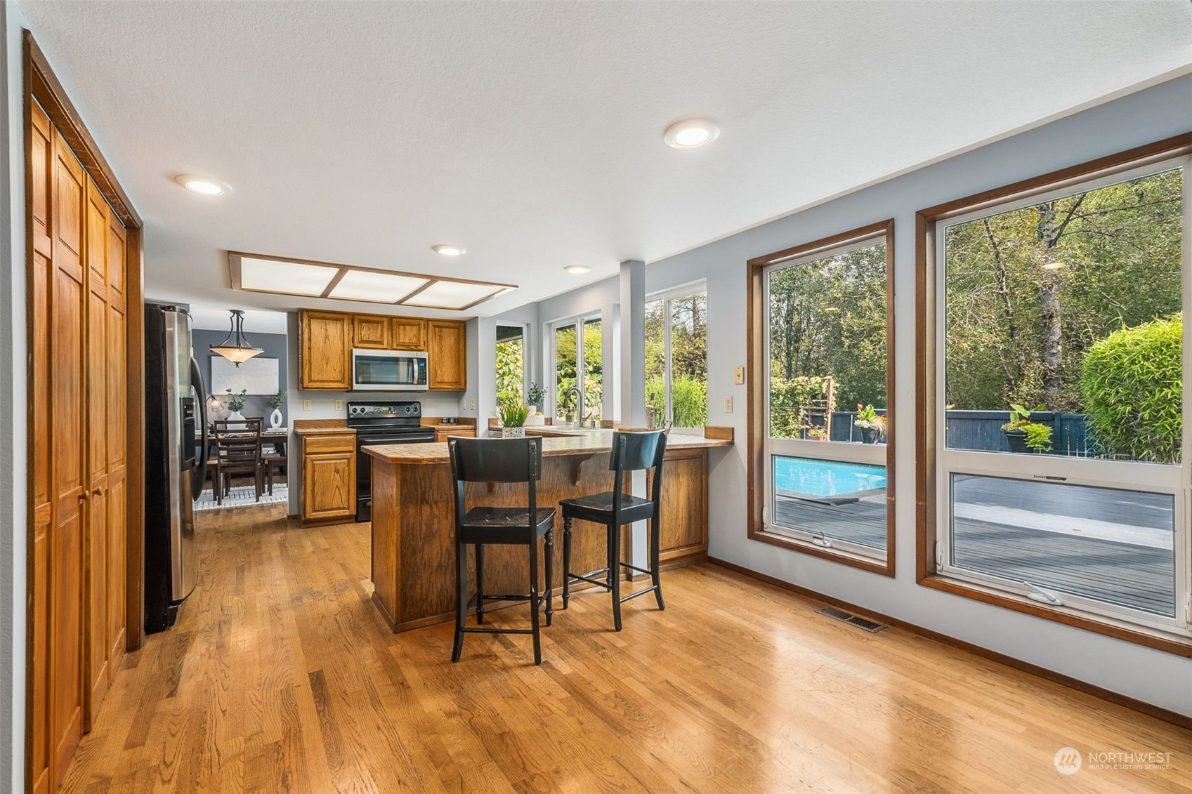 16902 161st Avenue Southeast Renton, WA 98058 - Photo 12 of 29 a view of a dining room with furniture and a floor to ceiling window