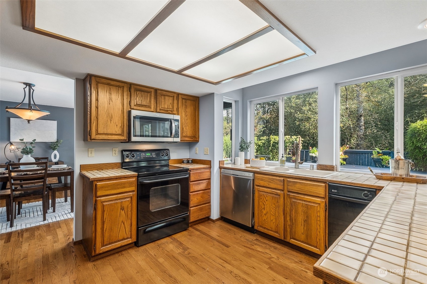 16902 161st Avenue Southeast Renton, WA 98058 - Photo 13 of 29 a kitchen with stainless steel appliances granite countertop a stove and a sink