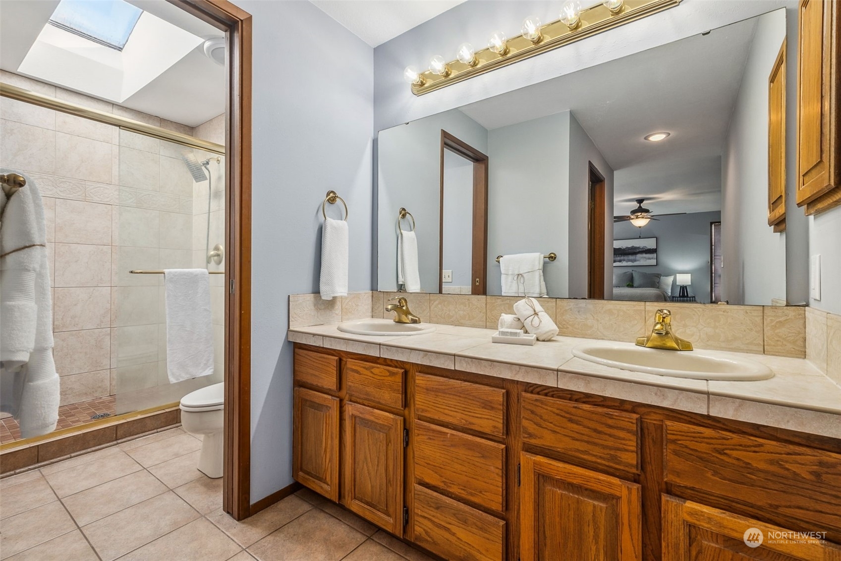 16902 161st Avenue Southeast Renton, WA 98058 - Photo 19 of 29 a bathroom with a granite countertop sink and a mirror