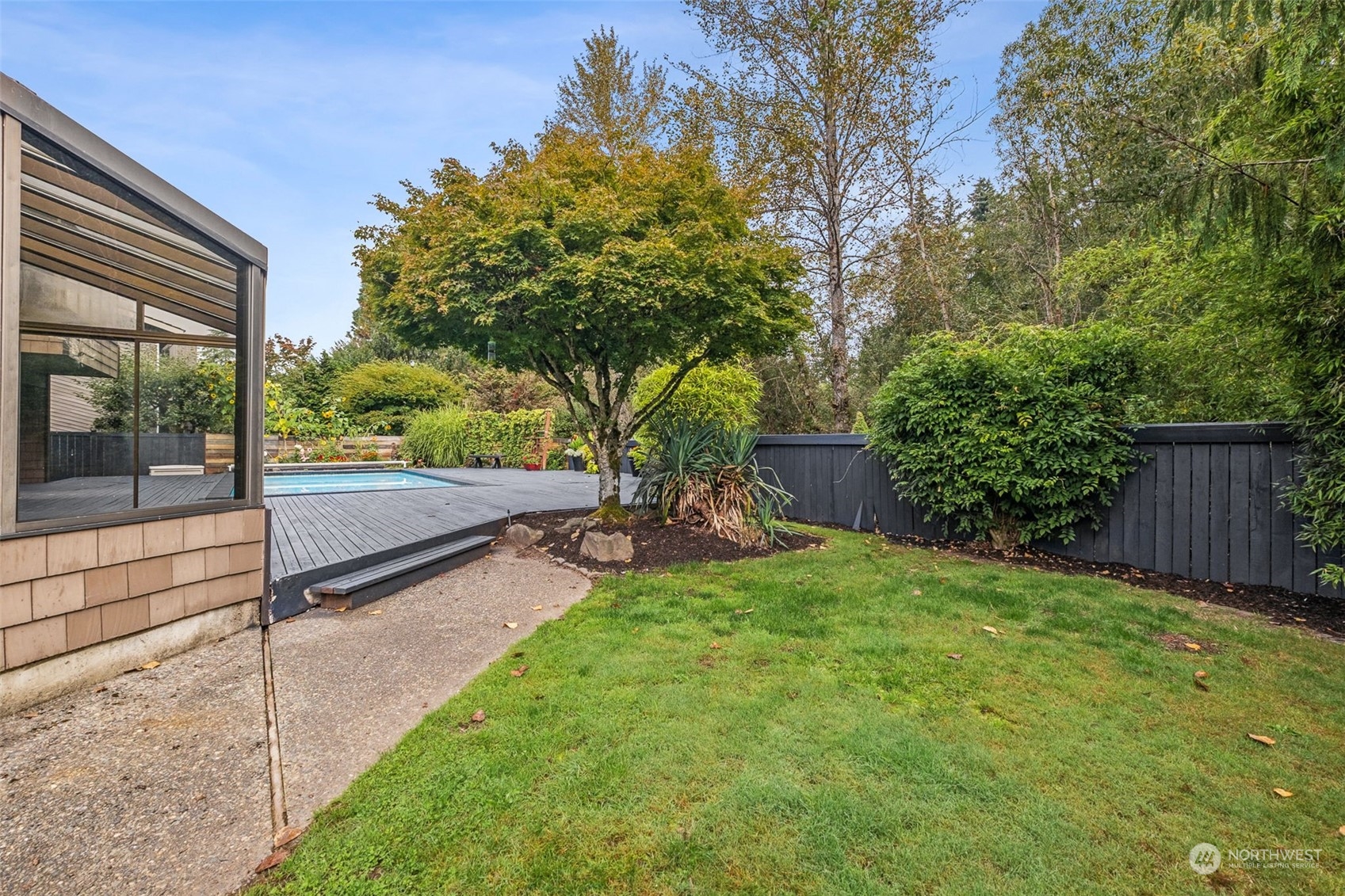 16902 161st Avenue Southeast Renton, WA 98058 - Photo 24 of 29 a view of a backyard with table and chairs and wooden fence