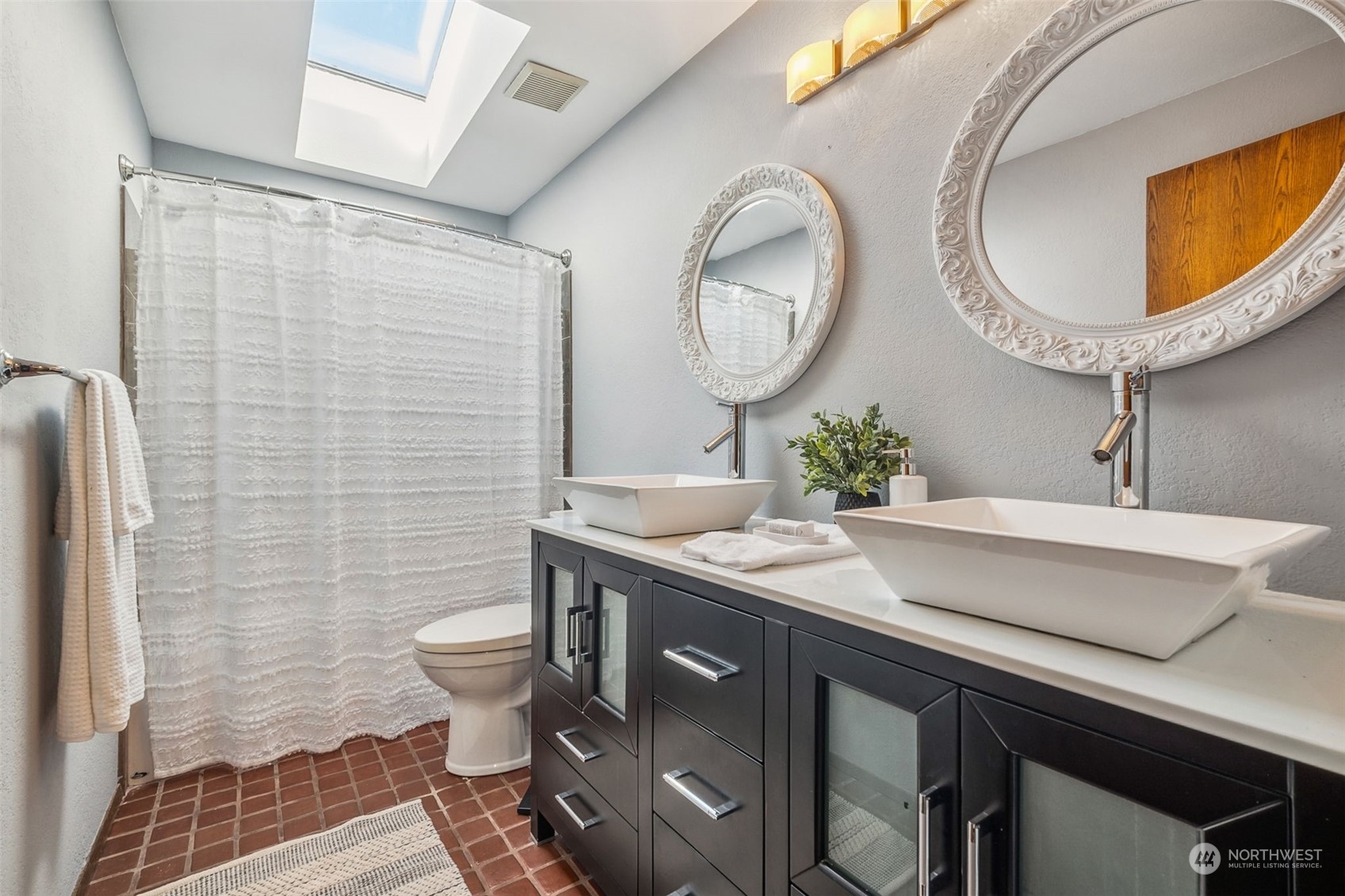 16902 161st Avenue Southeast Renton, WA 98058 - Photo 27 of 29 a bathroom with a sink and a mirror