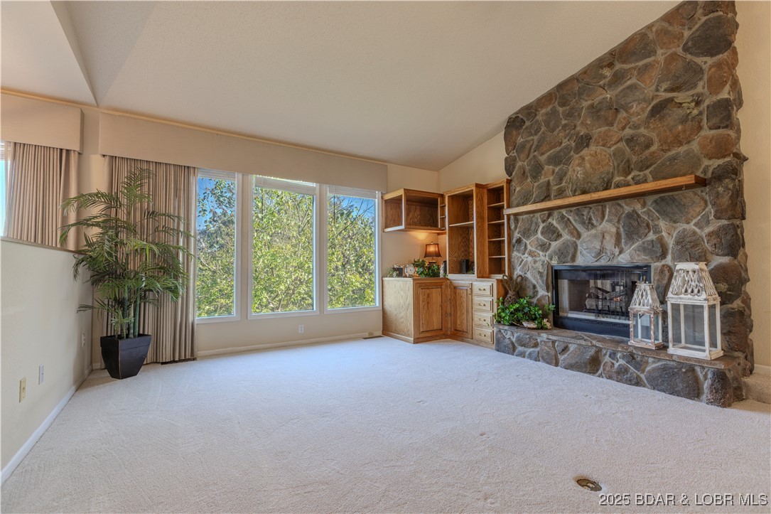 270 Country Club Shores Road Camdenton, MO 65020 - Photo 3 of 23 Big windows with a cozy stone fireplace in a sunke