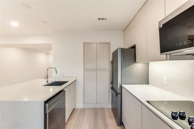a kitchen with a refrigerator and a sink