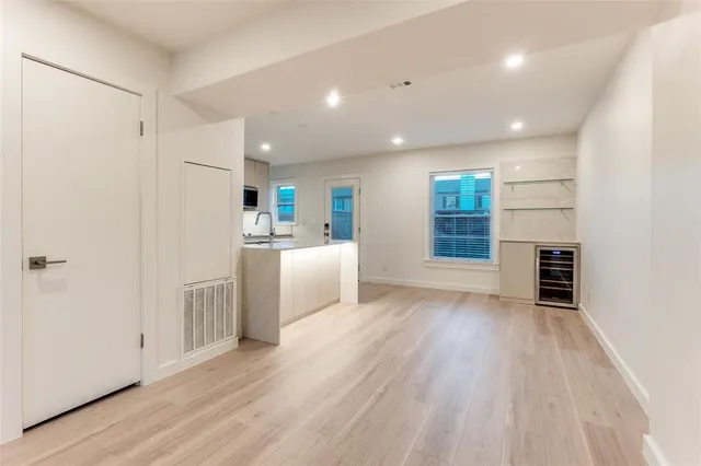 a view of a kitchen with a sink and a refrigerator