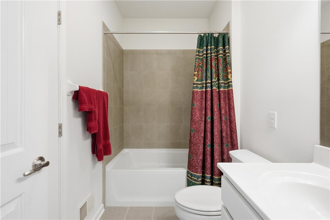 4120 Eveningstar Road Emmaus, PA 18049 - Photo 35 of 62 A well-appointed bathroom features a bathtub with a tile surround and a convenient vanity.