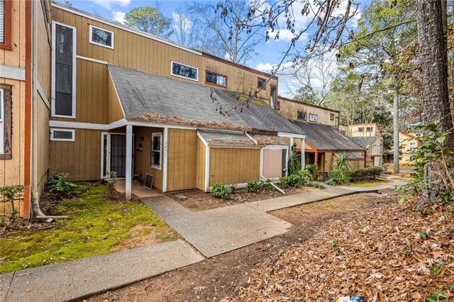 a front view of a house with a yard outdoor seating and garage
