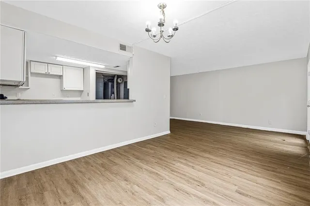 a view of a kitchen with wooden floor and a ceiling fan