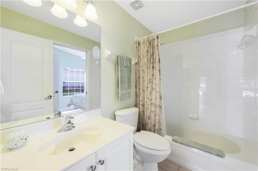 6667 Castlelawn Place, Unit 19 Naples, FL 34113 - Photo 17 of 31 a bathroom with a sink toilet and shower