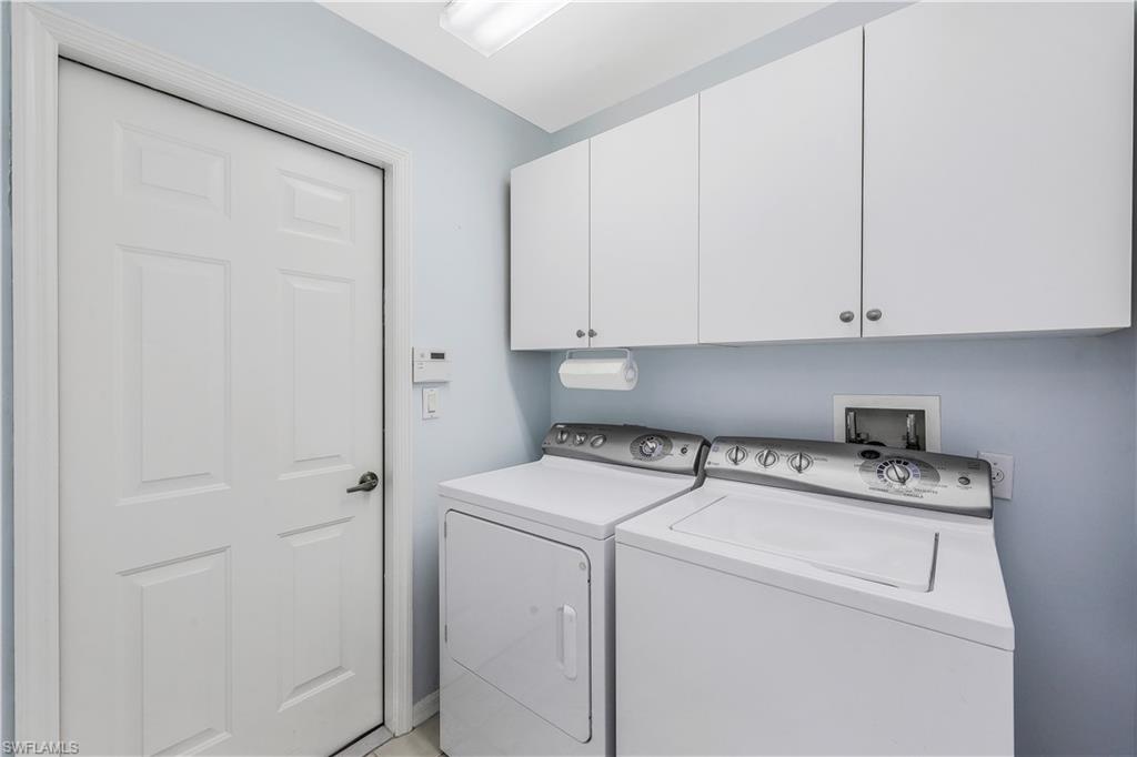 6667 Castlelawn Place, Unit 19 Naples, FL 34113 - Photo 19 of 31 a utility room with dryer and washer