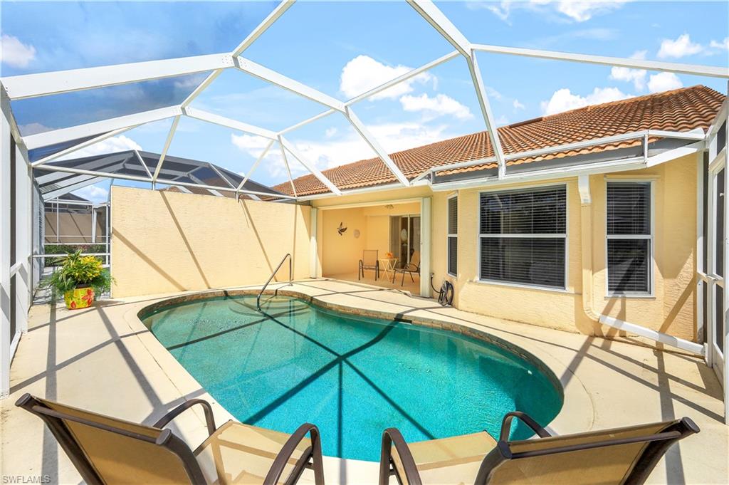 6667 Castlelawn Place, Unit 19 Naples, FL 34113 - Photo 2 of 31 a house view with a seating space