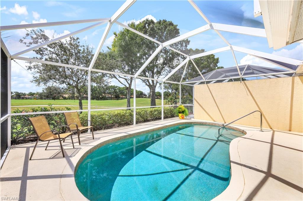 6667 Castlelawn Place, Unit 19 Naples, FL 34113 - Photo 21 of 31 a view of a balcony with table and chairs