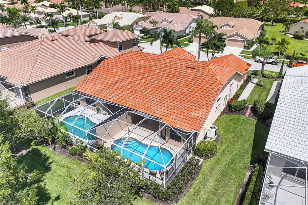 6667 Castlelawn Place, Unit 19 Naples, FL 34113 - Photo 22 of 31 an aerial view of a house with a yard