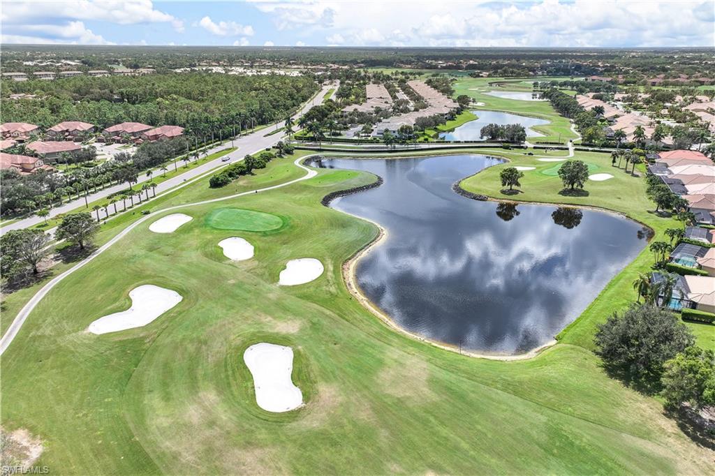 6667 Castlelawn Place, Unit 19 Naples, FL 34113 - Photo 24 of 31 a view of a lake with a swimming pool