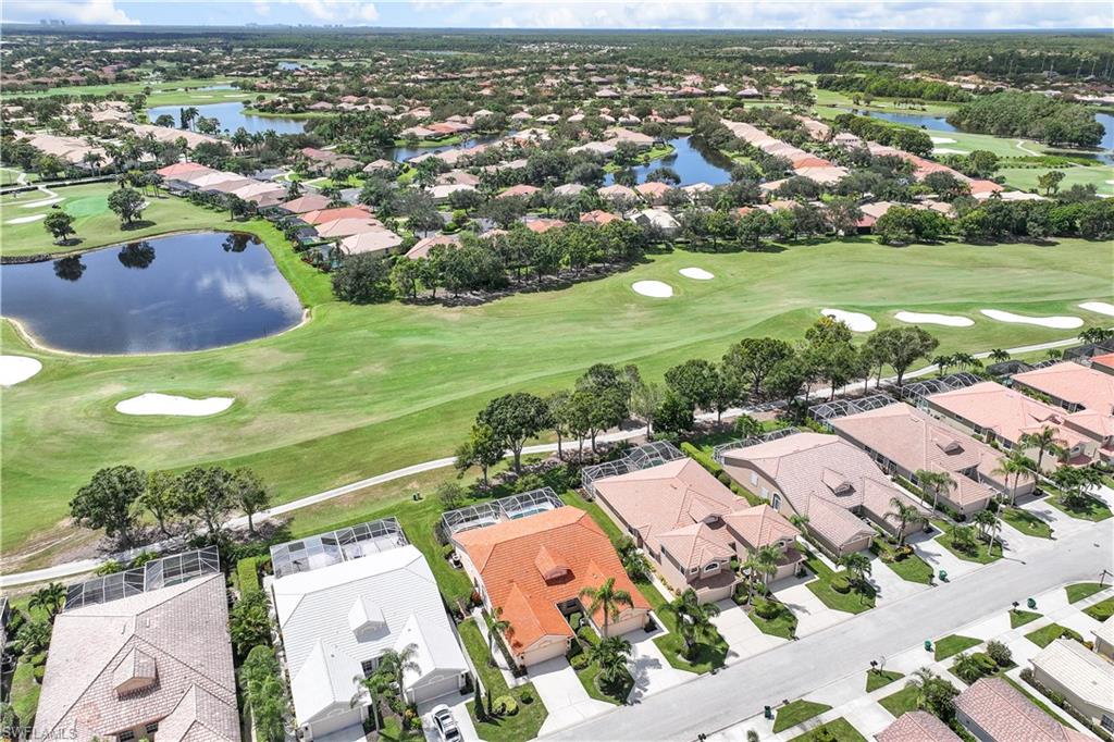 6667 Castlelawn Place, Unit 19 Naples, FL 34113 - Photo 26 of 31 an aerial view of residential houses with outdoor space