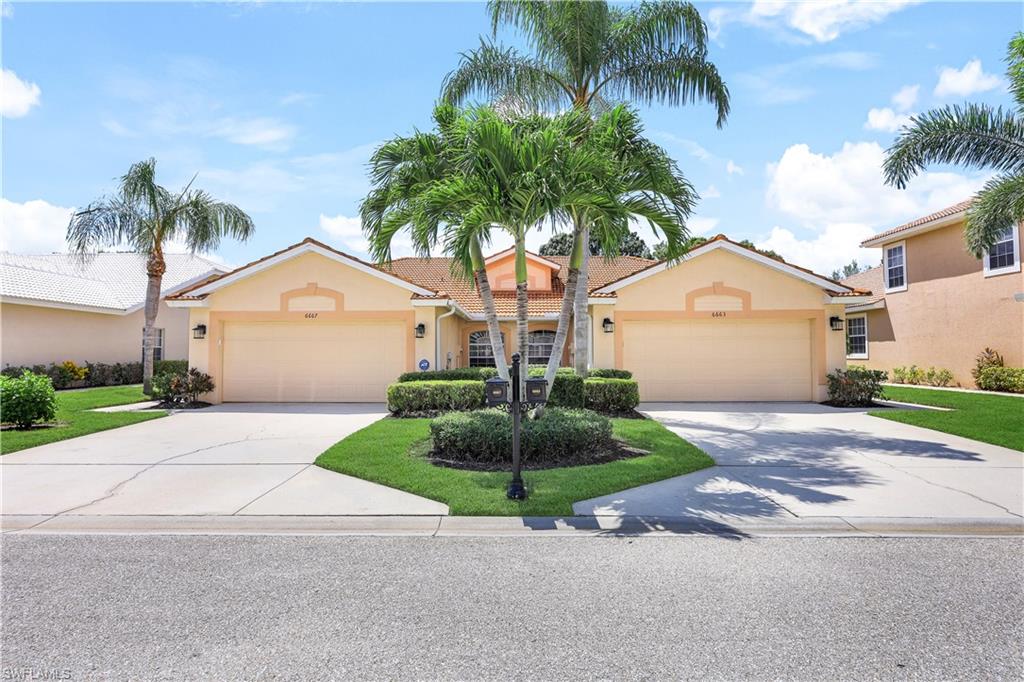 6667 Castlelawn Place, Unit 19 Naples, FL 34113 - Photo 4 of 31 a palm tree sitting in front of a house with a yard