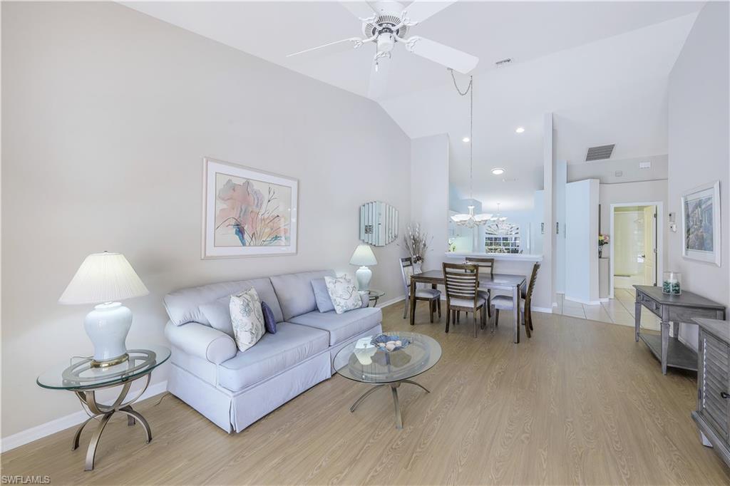 6667 Castlelawn Place, Unit 19 Naples, FL 34113 - Photo 7 of 31 a living room with furniture and a table