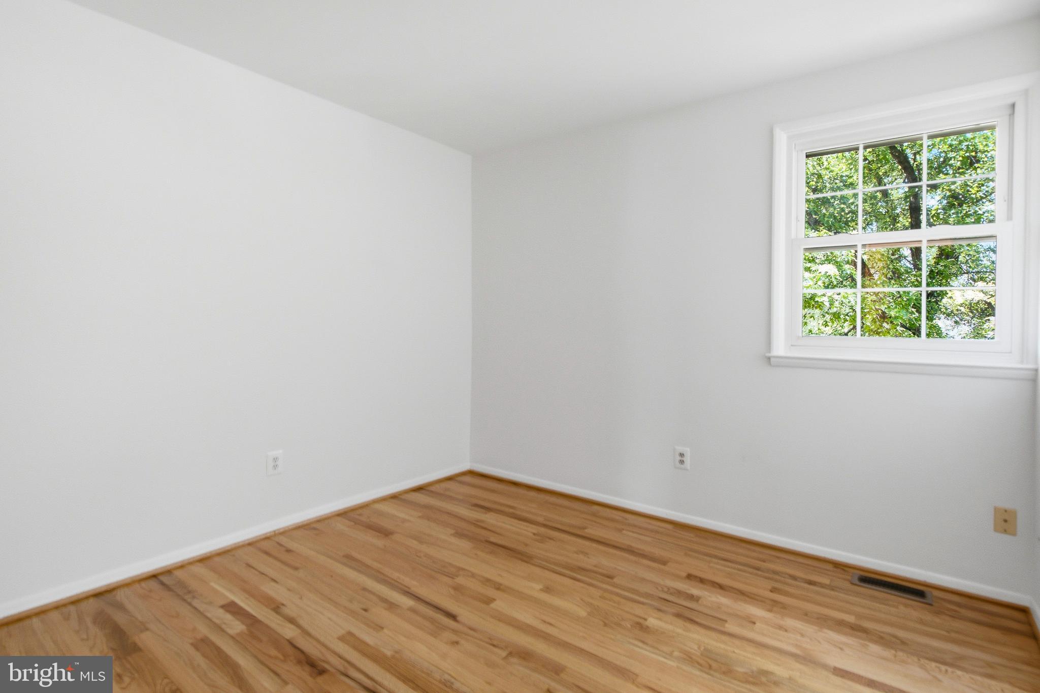 220 Solway Road Lutherville-Timonium, MD 21093 - Photo 19 of 38 a view of empty room with wooden floor and fan