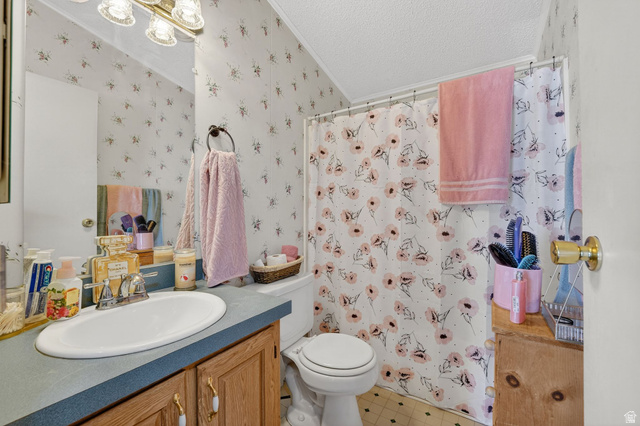269 Mindella Way, Unit A Layton, UT 84041 - Photo 20 of 37 Bathroom featuring vanity, curtained shower, a textured ceiling, tile patterned floors, and crown molding