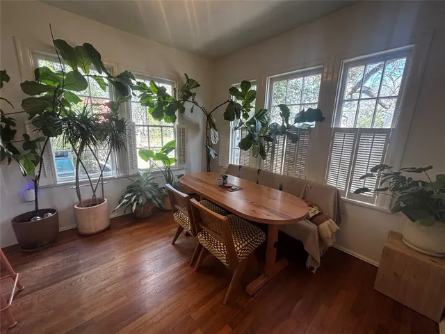 a kitchen with granite countertop a refrigerator and white cabinets