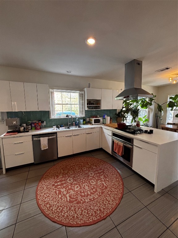 917 East 39th Street Austin, TX 78751 - Photo 20 of 27 a kitchen with stainless steel appliances kitchen island granite countertop a stove a sink a counter space and cabinets