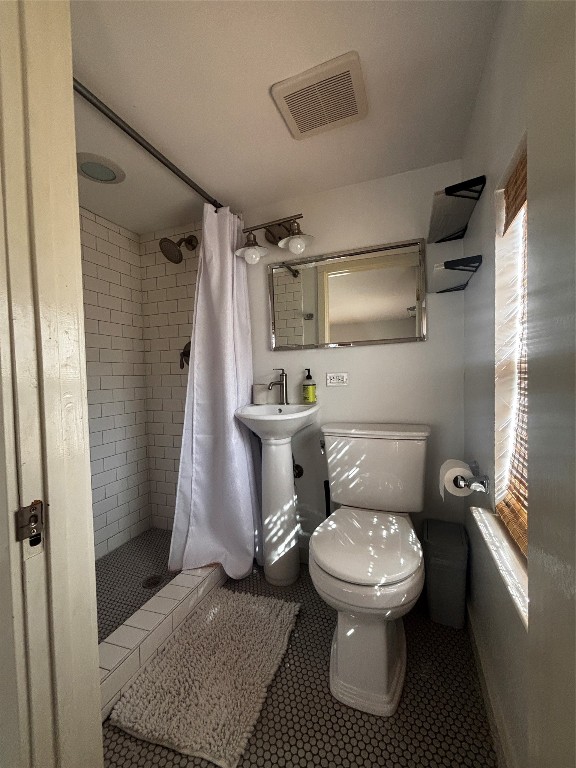 917 East 39th Street Austin, TX 78751 - Photo 24 of 27 a white toilet sitting next to a bathroom sink
