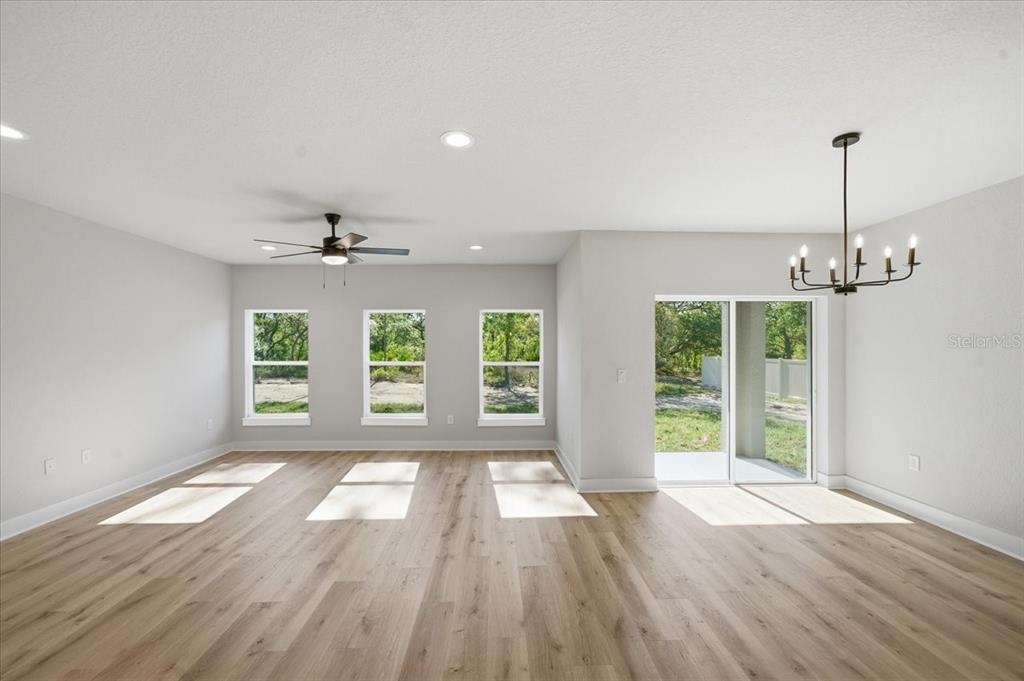 15212 Hawley Road Weeki Wachee, FL 34614 - Photo 13 of 25 a view of an empty room with wooden floor fireplace and a window