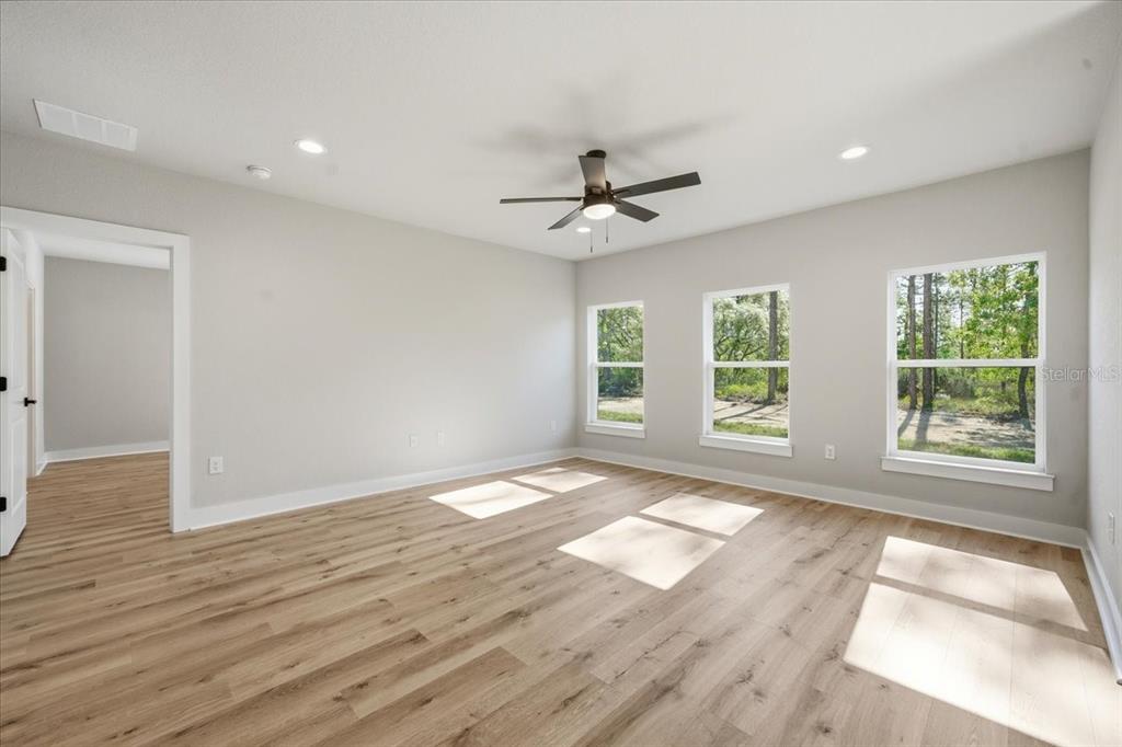 15212 Hawley Road Weeki Wachee, FL 34614 - Photo 14 of 25 a view of an empty room with wooden floor and a window