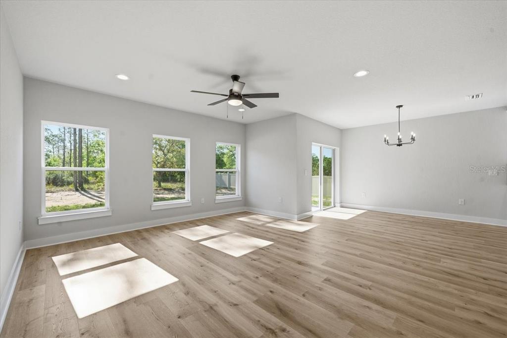 15212 Hawley Road Weeki Wachee, FL 34614 - Photo 15 of 25 a view of an empty room with a window and a kitchen