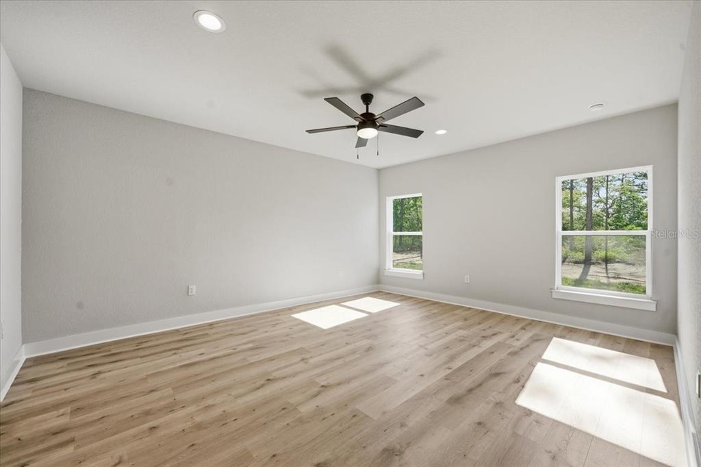 15212 Hawley Road Weeki Wachee, FL 34614 - Photo 16 of 25 wooden floor in an empty room with a window