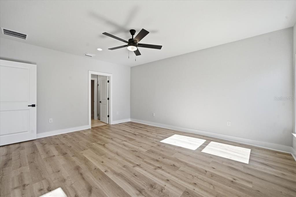 15212 Hawley Road Weeki Wachee, FL 34614 - Photo 17 of 25 a view of empty room with wooden floor and fan