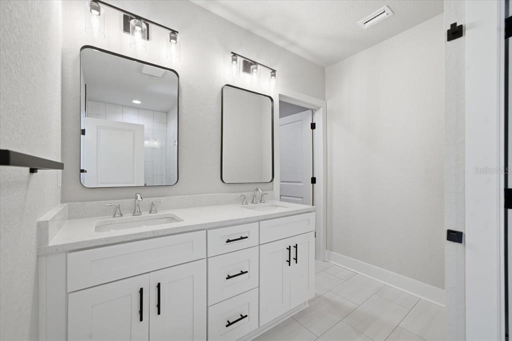 15212 Hawley Road Weeki Wachee, FL 34614 - Photo 18 of 25 a bathroom with a double vanity sink mirror and
