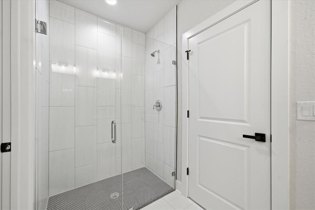 15212 Hawley Road Weeki Wachee, FL 34614 - Photo 19 of 25 a bathroom with a glass shower door