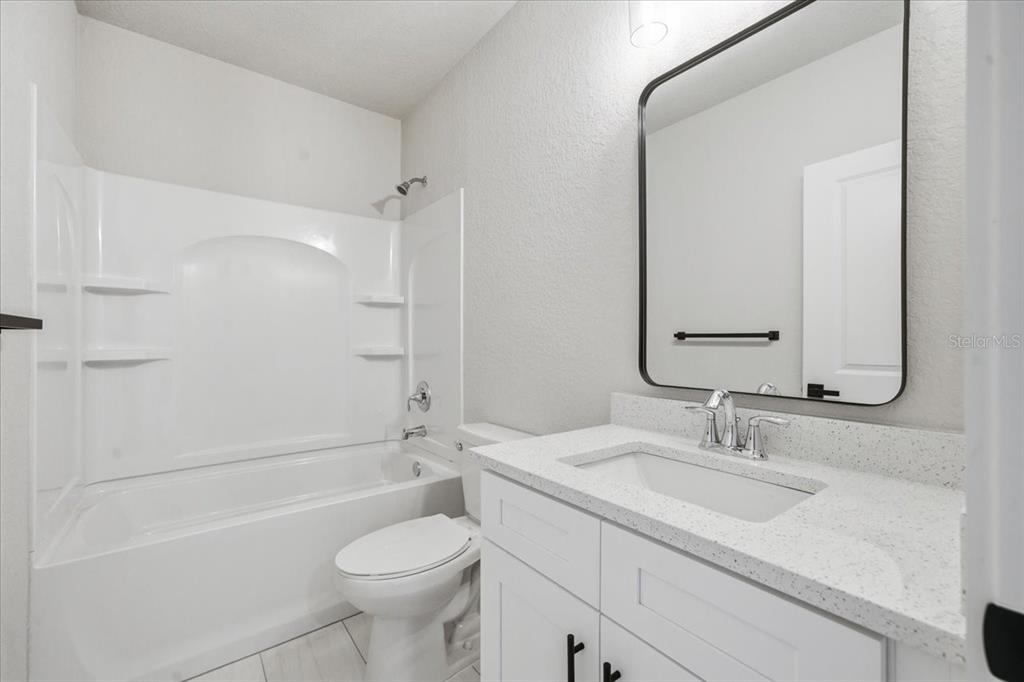 15212 Hawley Road Weeki Wachee, FL 34614 - Photo 22 of 25 a bathroom with a sink toilet vanity and shower