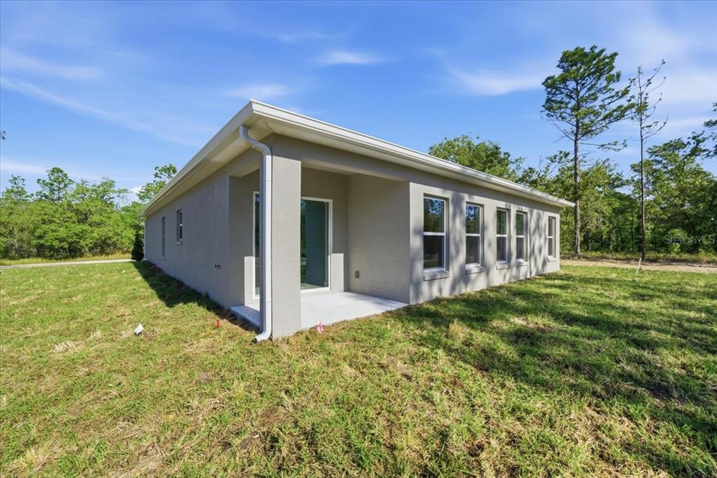 15212 Hawley Road Weeki Wachee, FL 34614 - Photo 24 of 25 a view of backyard with large trees and wooden fence