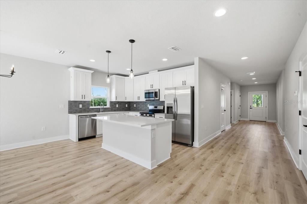 15212 Hawley Road Weeki Wachee, FL 34614 - Photo 4 of 25 a kitchen with refrigerator and cabinets