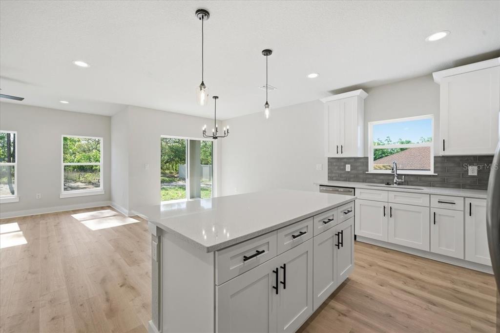 15212 Hawley Road Weeki Wachee, FL 34614 - Photo 8 of 25 a kitchen with white cabinets and window