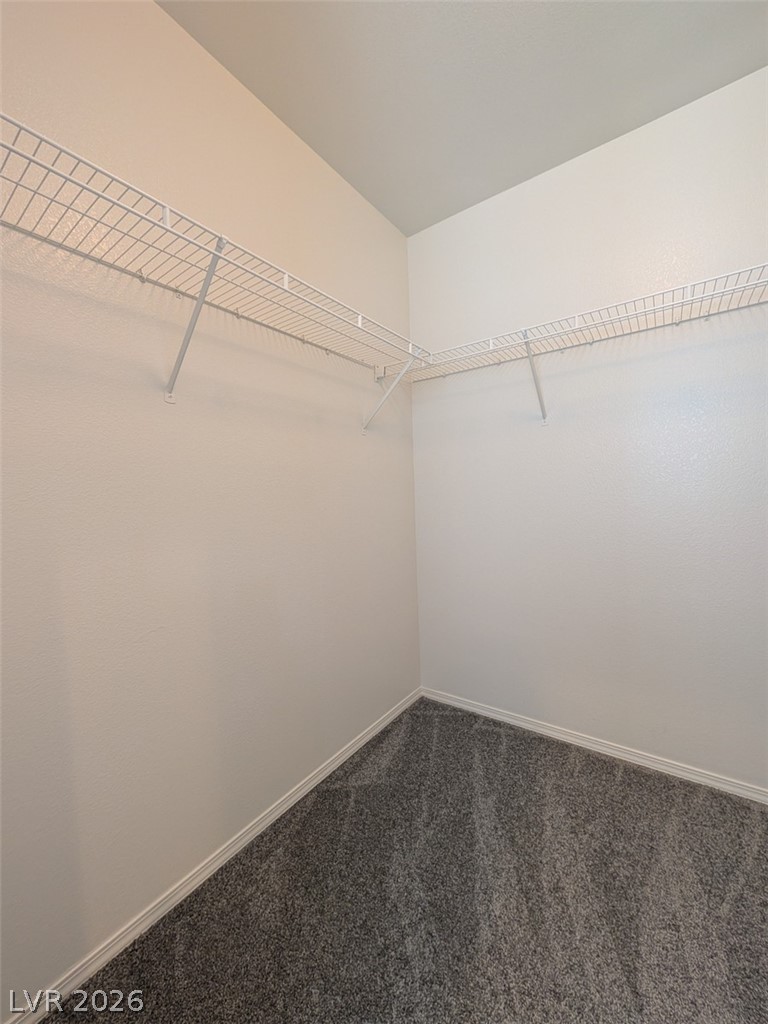 10308 Faustine Avenue Las Vegas, NV 89129 - Photo 11 of 28 Ready for personalization, this walk-in closet boasts ample shelving and soft carpet.