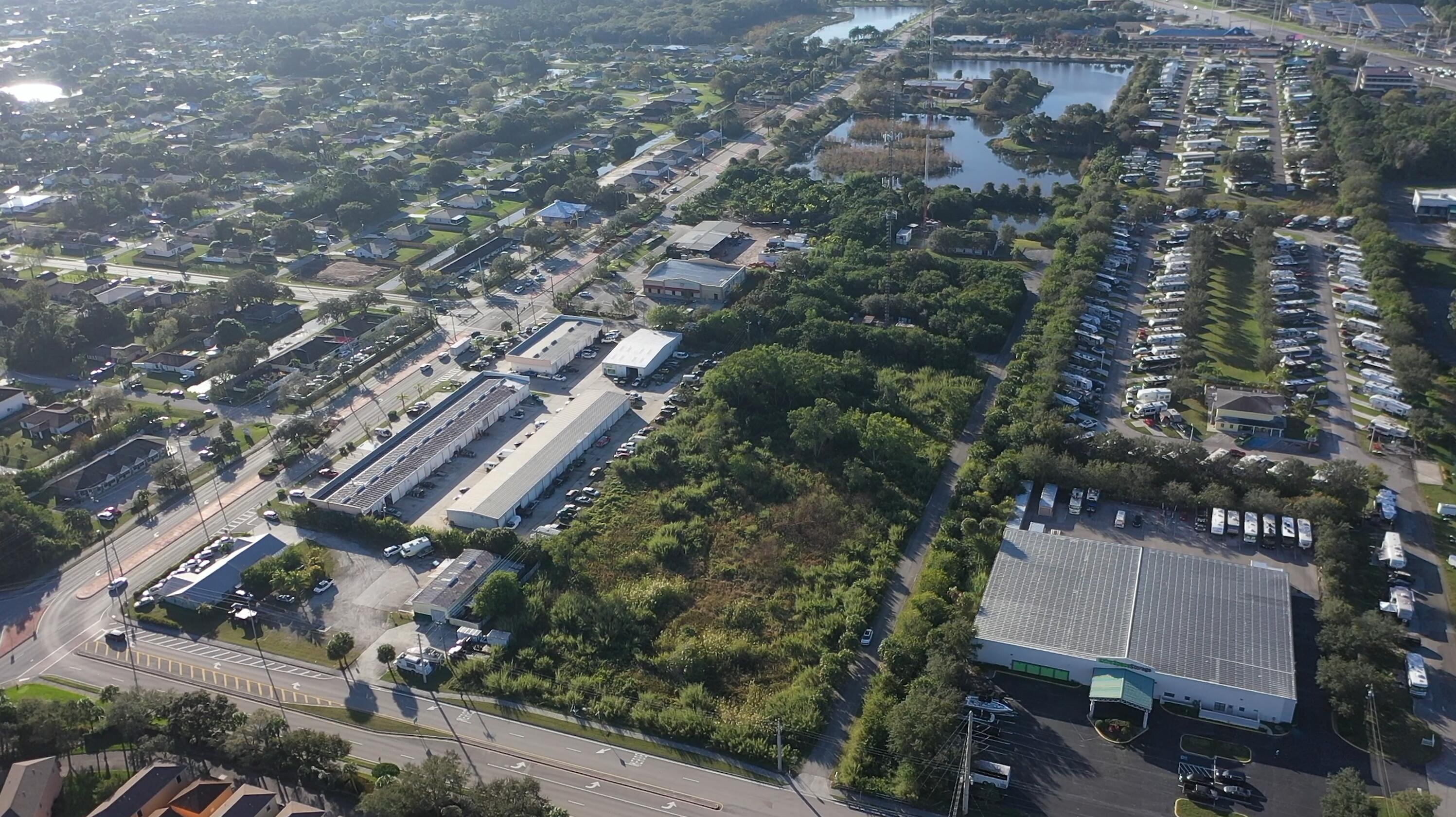 3775 Southeast Jennings Road Port St. Lucie, FL 34952 - Photo 9 of 14 an aerial view of a residential apartment building with a yard and parking spaces