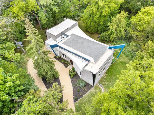 an aerial view of a house with a yard