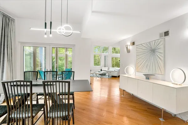 a kitchen with stainless steel appliances a sink a stove and wooden floor