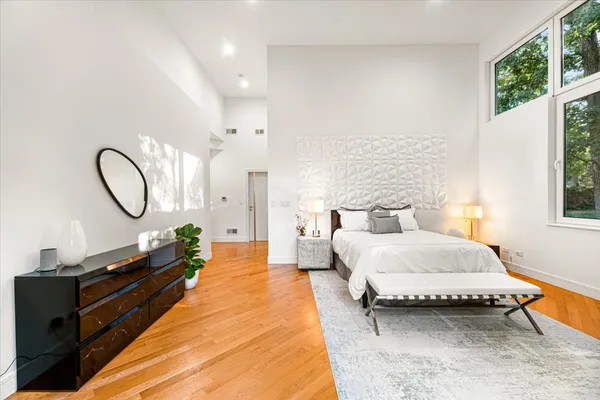 a bedroom with a bed and wooden floor