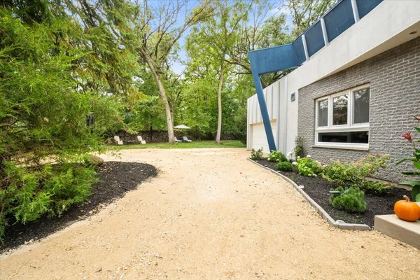 a house with potted plants in front of door