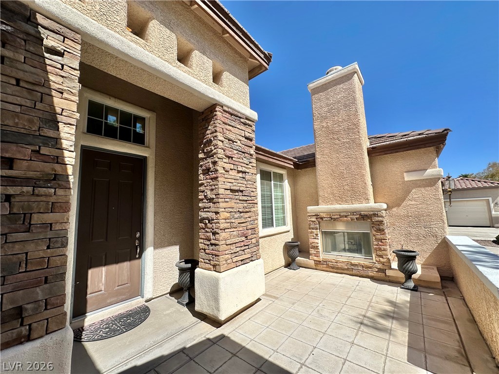9996 Liberty View Road Las Vegas, NV 89148 - Photo 27 of 64 DECORATIVE FIREPLACE IN COURTYARD ENTRY.