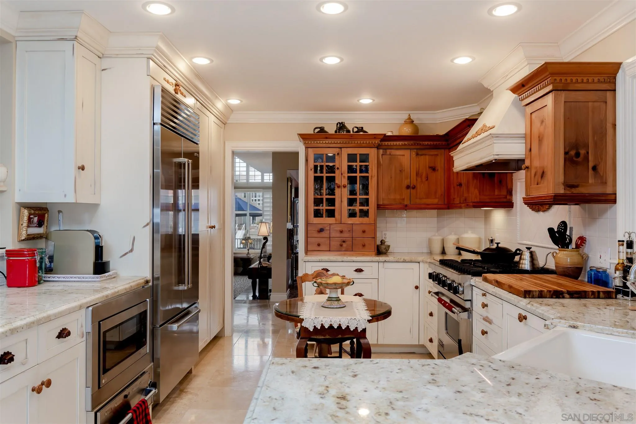 12 Buccaneer Way Coronado, CA 92118 - Photo 16 of 34 a kitchen with stainless steel appliances kitchen island granite countertop a refrigerator oven a sink dishwasher and white cabinets with wooden floor