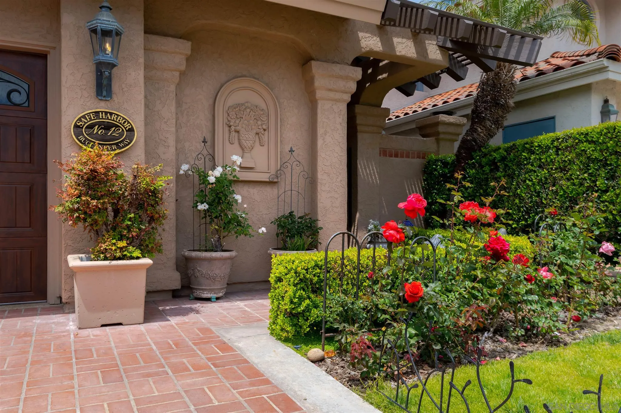 12 Buccaneer Way Coronado, CA 92118 - Photo 2 of 34 a front view of a house with a flower garden