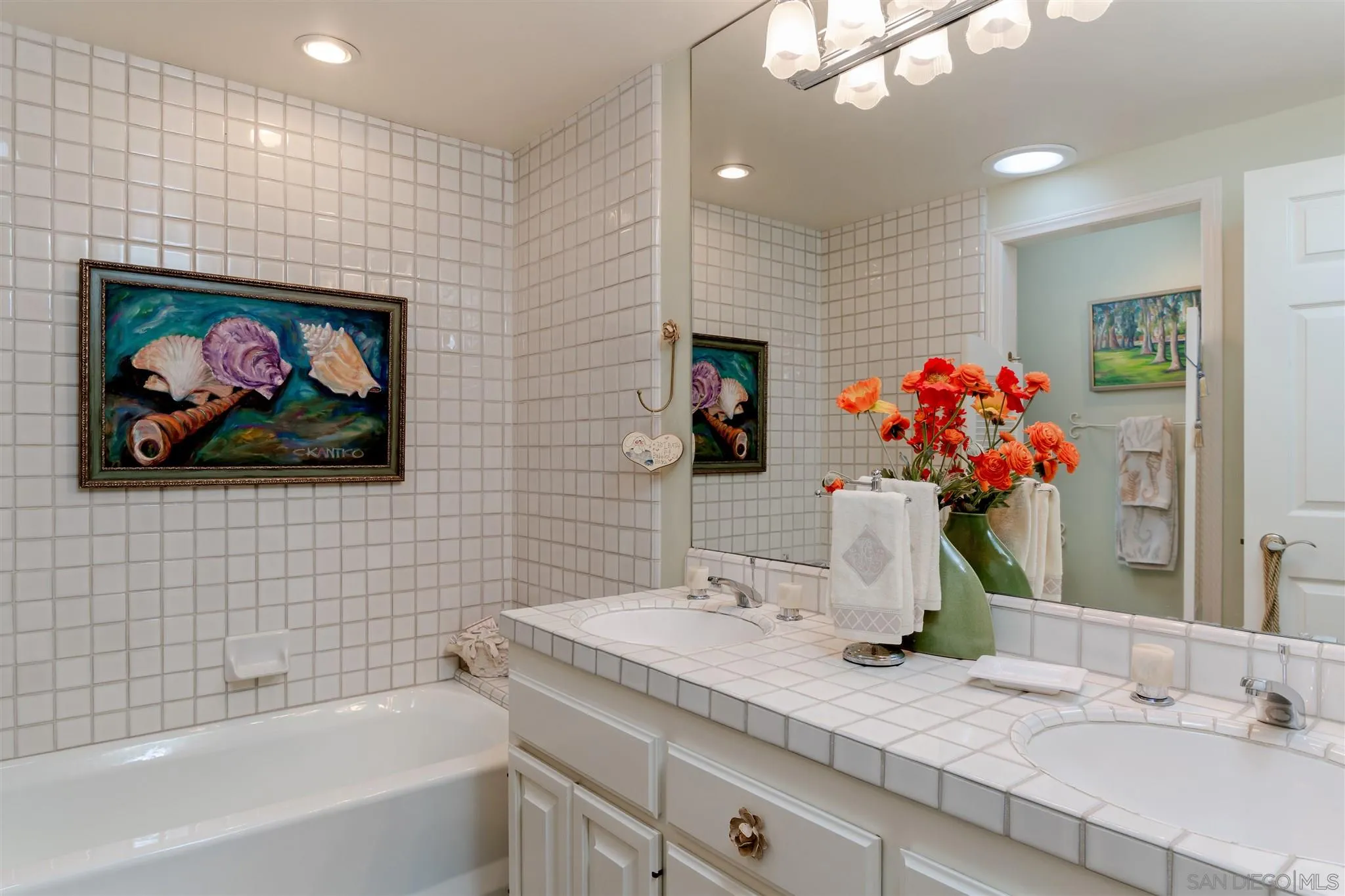 12 Buccaneer Way Coronado, CA 92118 - Photo 25 of 34 a bathroom with a granite countertop sink a large mirror and a bathtub
