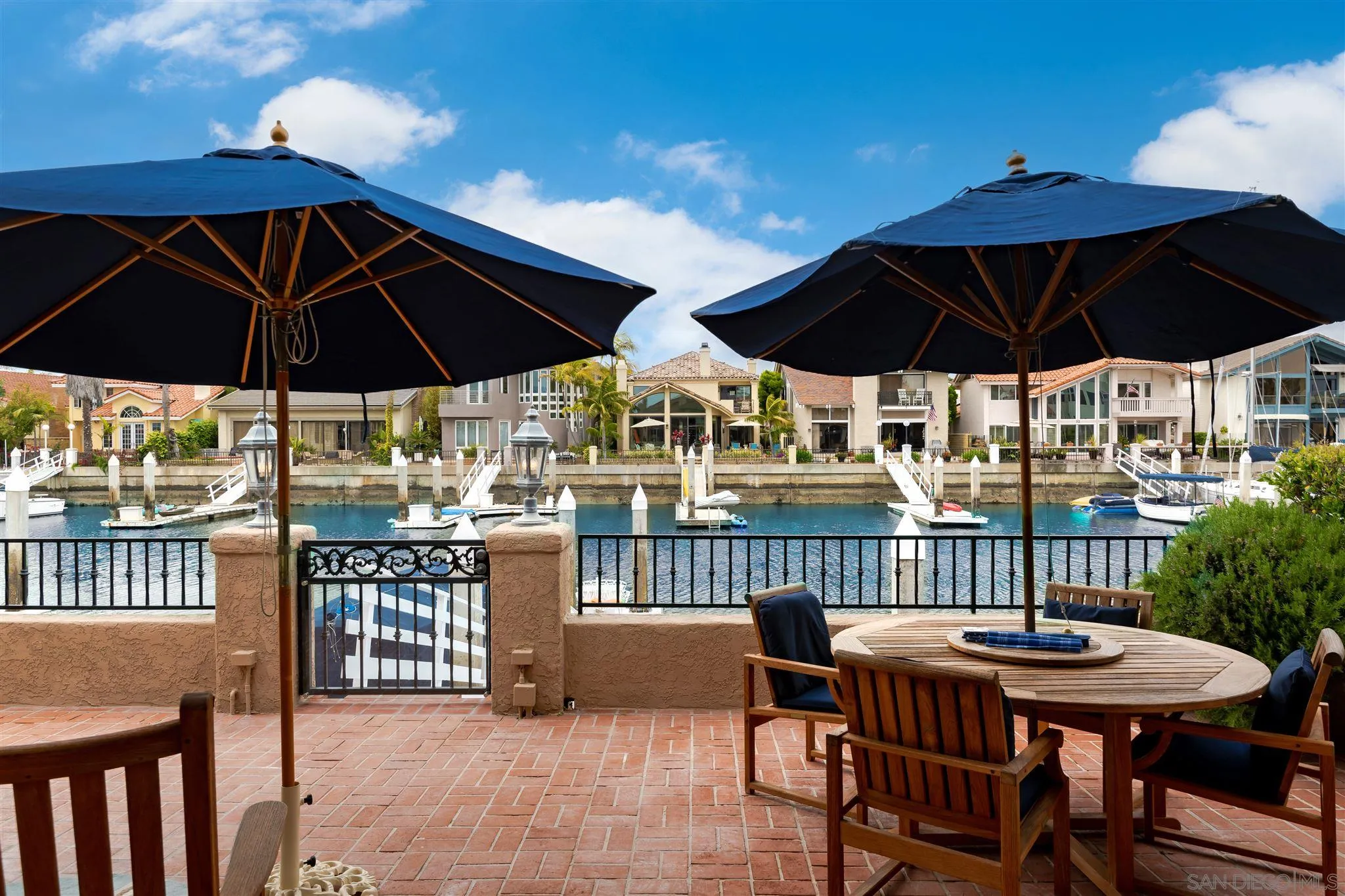 12 Buccaneer Way Coronado, CA 92118 - Photo 29 of 34 a view of a patio with a table and chairs under an umbrella